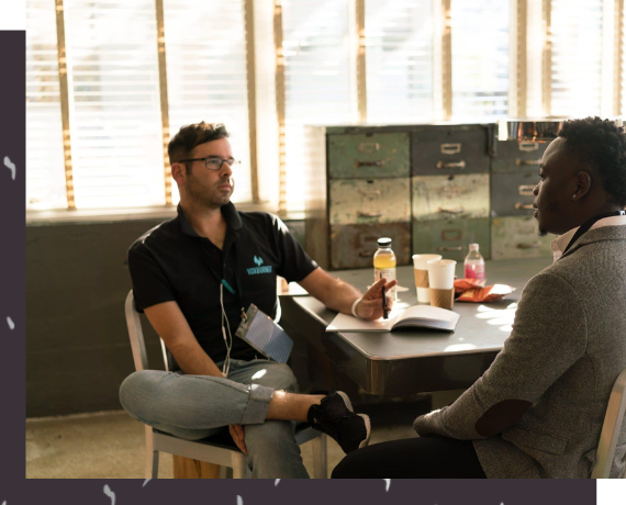 Manager and employee seating on the table having one on one conversation