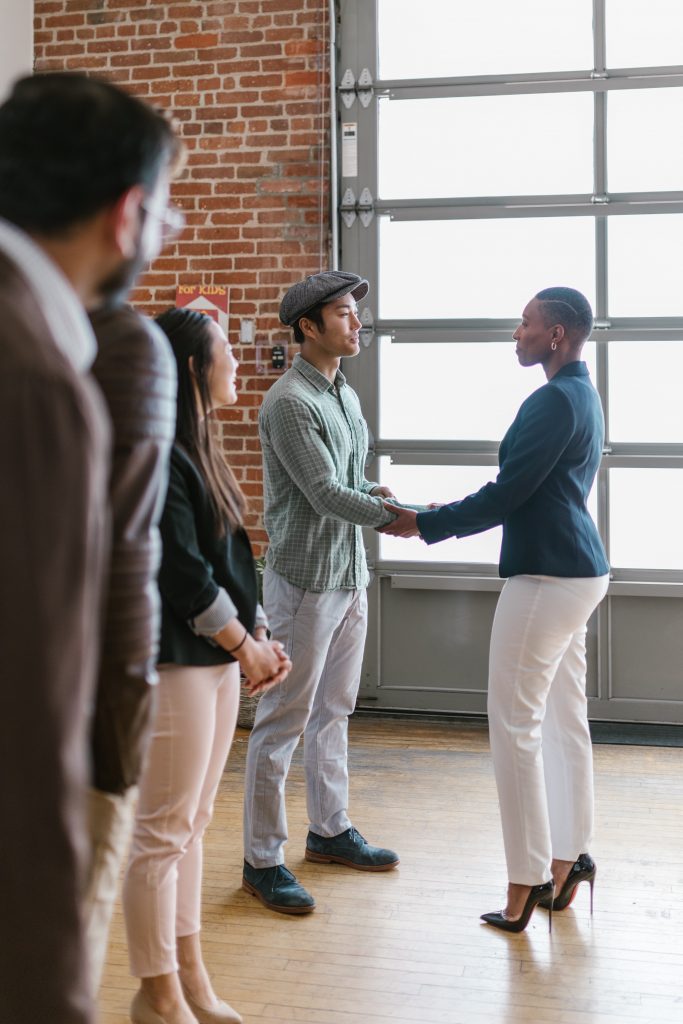 manager shaking hand by giving constructive feedback